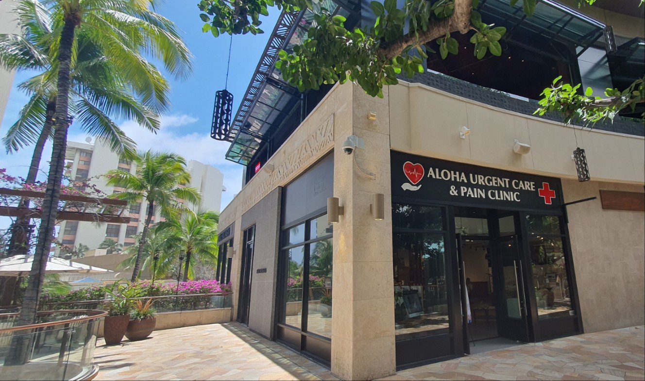 A building with palm trees in the background.