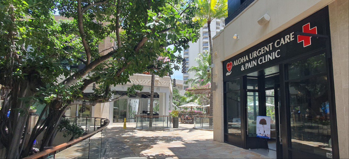 A building with trees and benches in the background.